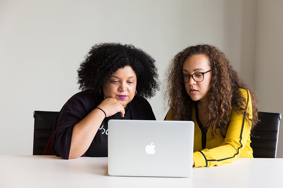 women working on a lap top